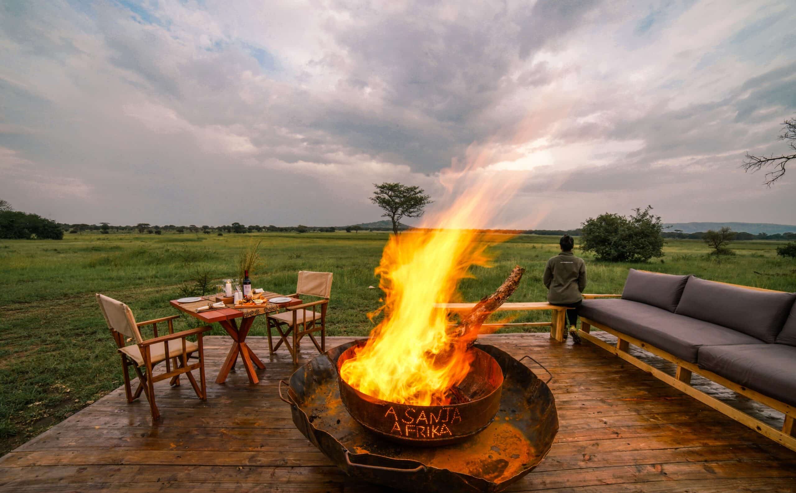 Fireside private dining on a deck overlooking the Serengeti plains at Asanja Grumeti, Tanzania