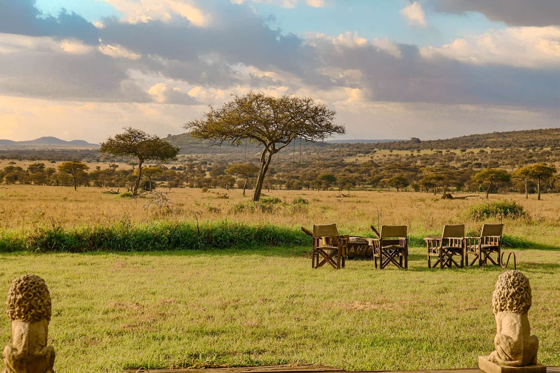 Safari chairs around a fire pit at Asanja Grumeti luxury tented camp overlooking the Serengeti plains